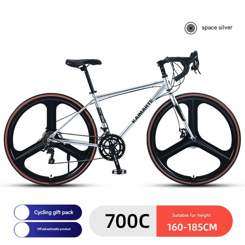 A silver road racing bicycle with curved handlebars, labeled with '700C' and 'space silver'. It features a dual disc brake system, a chain drive, and is designed for adult riders.